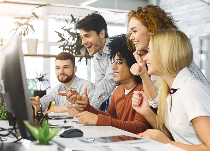 young team looking at computer screen in office to 2021 08 26 16 32 28 utc
